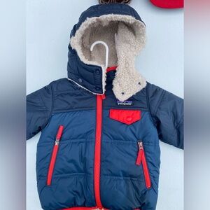 Toddler boy, navy, and red trim, Patagonia coat.